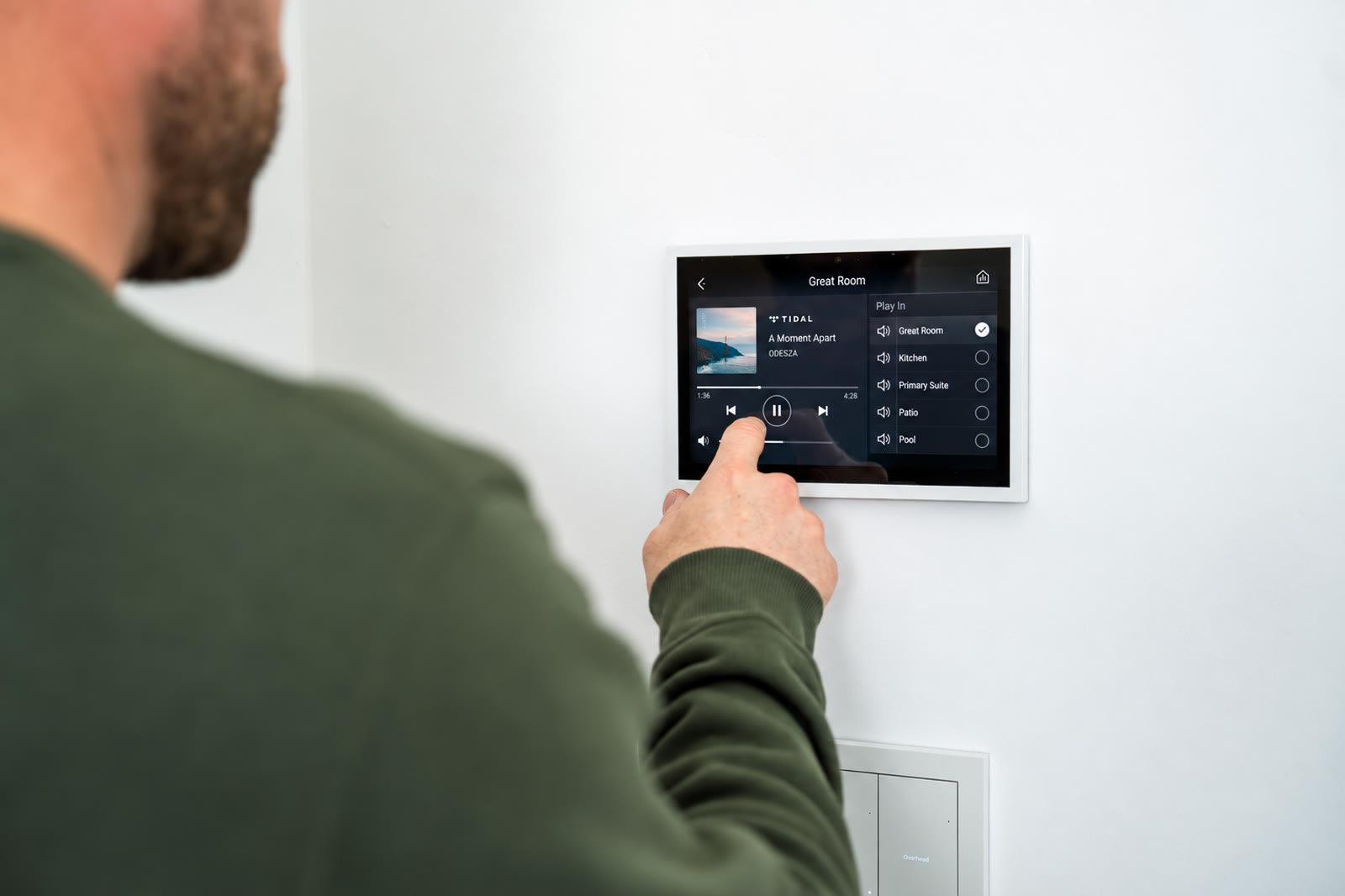 Control4 touchscreen showing TIDAL music and room selection